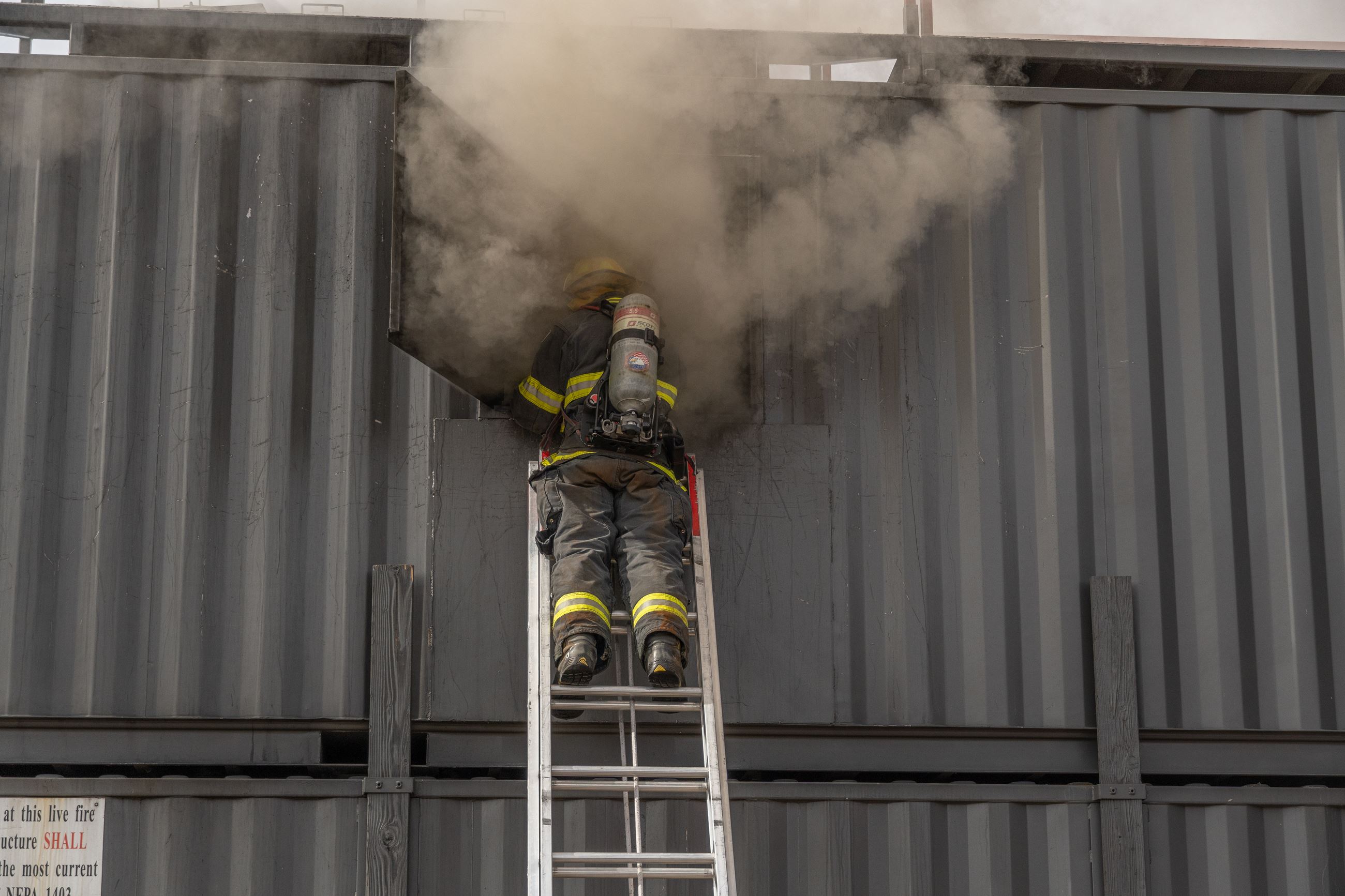Explorer on a ladder completing a fire drill